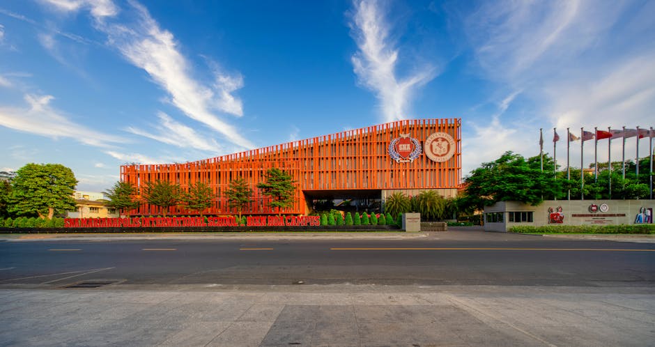 馬來西亞國際學校 — Vibrant orange facade of an international school against a c