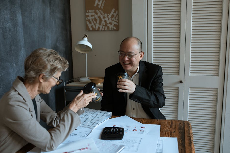 台馬跨境稅務 — Business professionals sharing coffee and charts at an offic