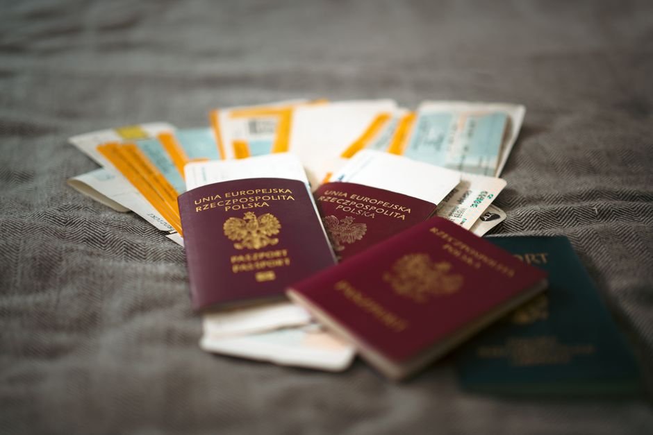 MM2H 適合誰 — Close-up of Polish passports and travel tickets symbolizing